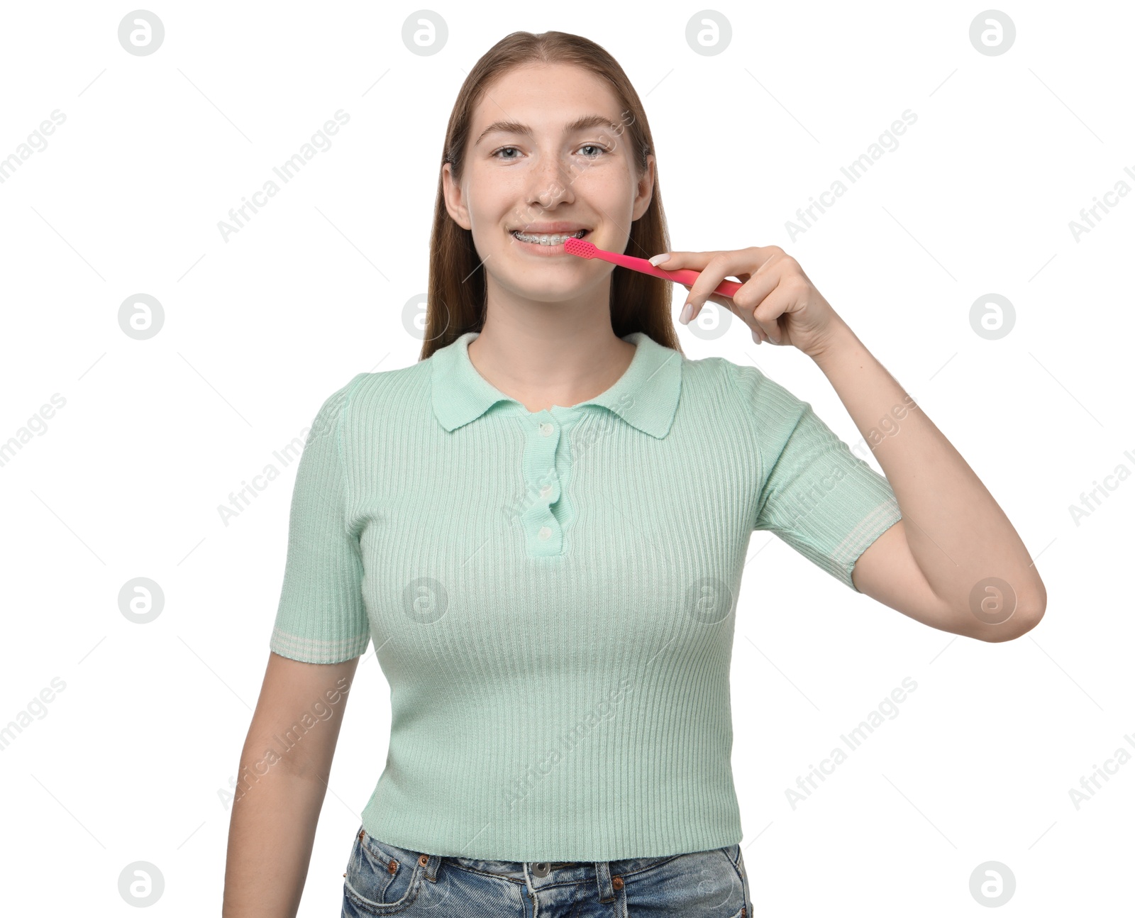 Photo of Girl with braces cleaning teeth on white background