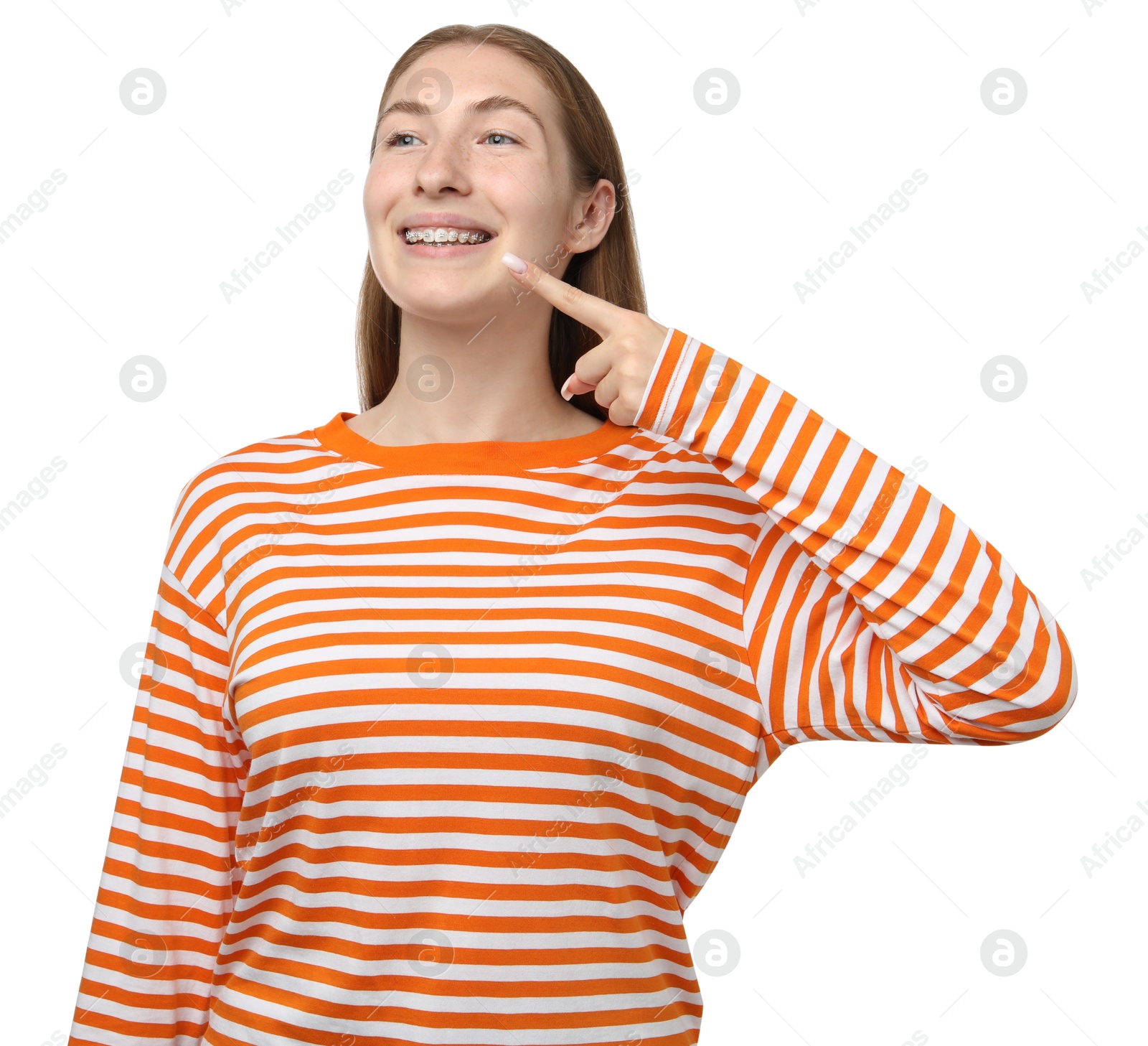 Photo of Smiling girl pointing at her braces on white background