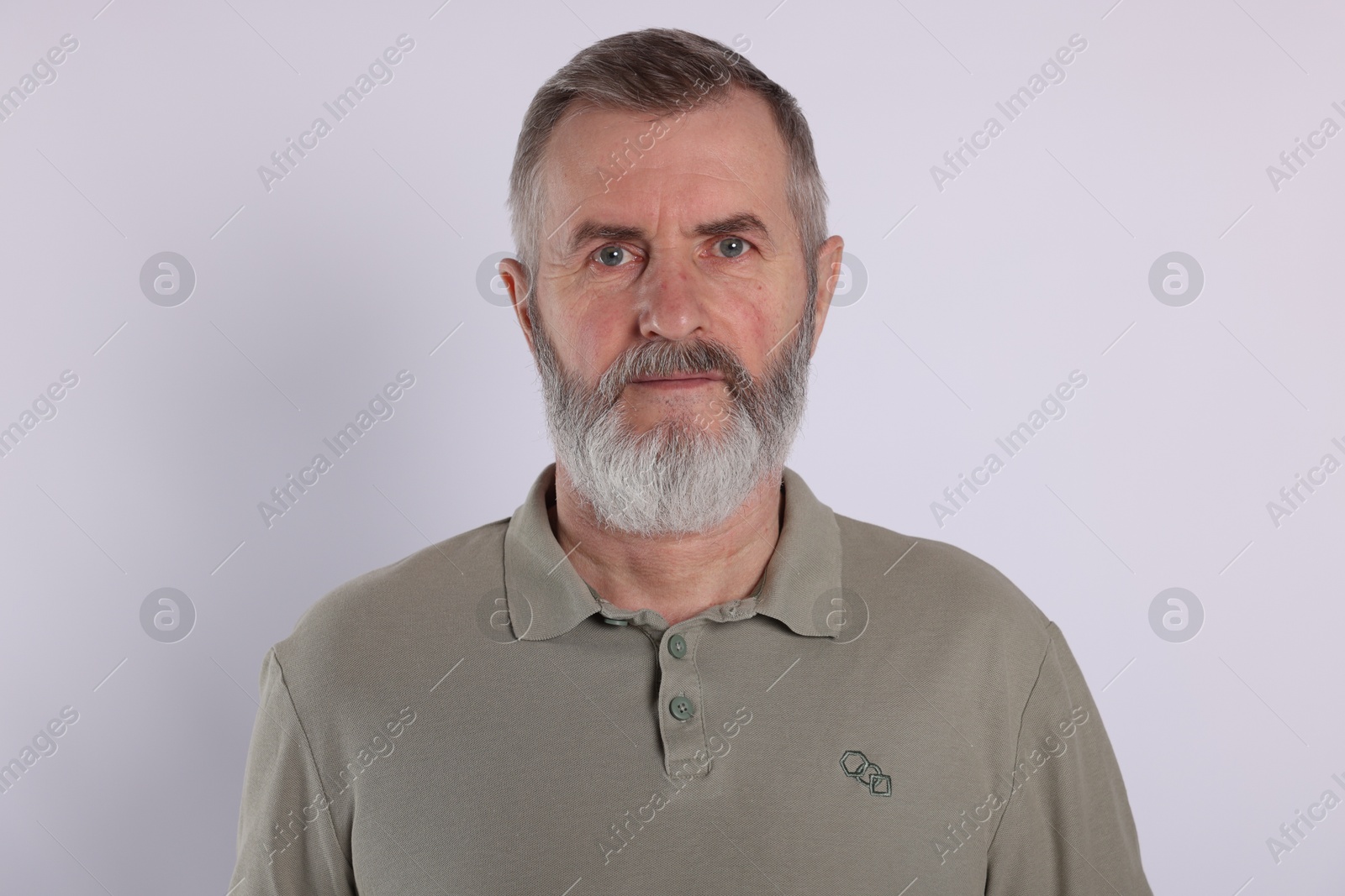 Photo of Portrait of senior man on white background