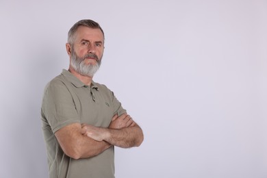 Portrait of senior man on white background, space for text