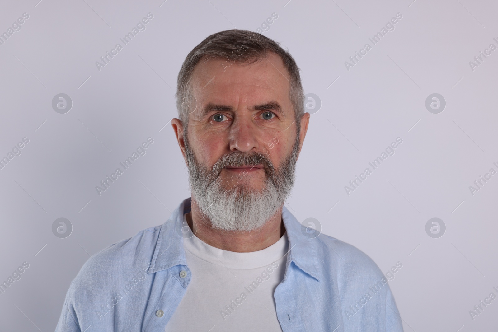 Photo of Portrait of senior man on white background