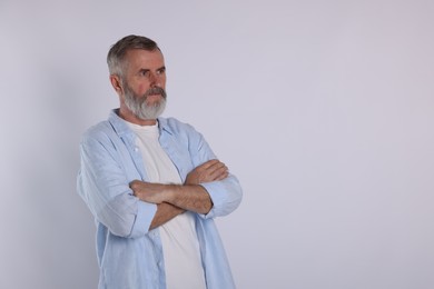 Portrait of senior man on white background, space for text