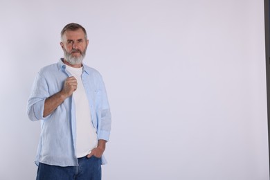 Portrait of senior man on white background, space for text