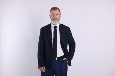 Photo of Portrait of senior man in suit on white background