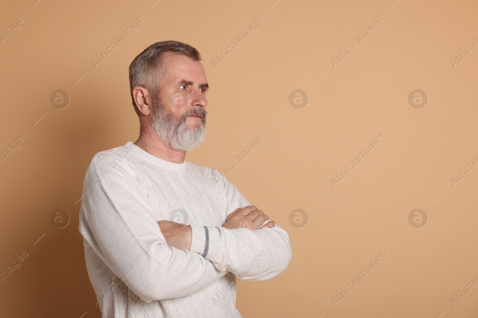 Photo of Portrait of senior man on beige background, space for text