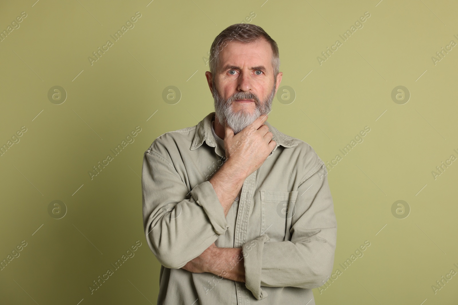 Photo of Portrait of senior man on green background