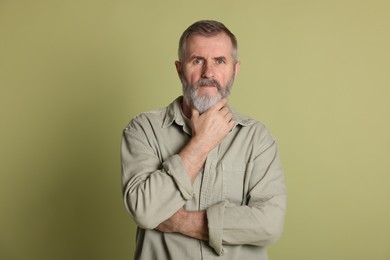 Photo of Portrait of senior man on green background