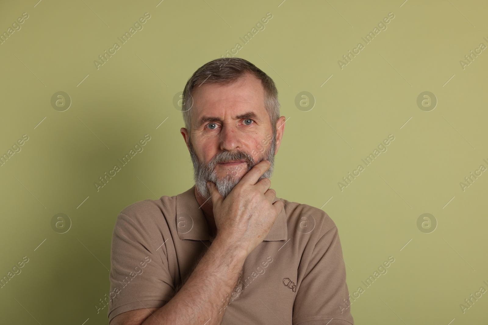 Photo of Portrait of senior man on green background