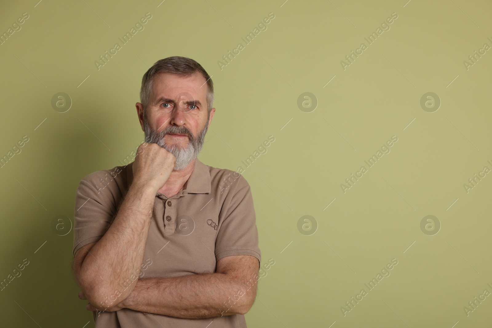 Photo of Portrait of senior man on green background, space for text