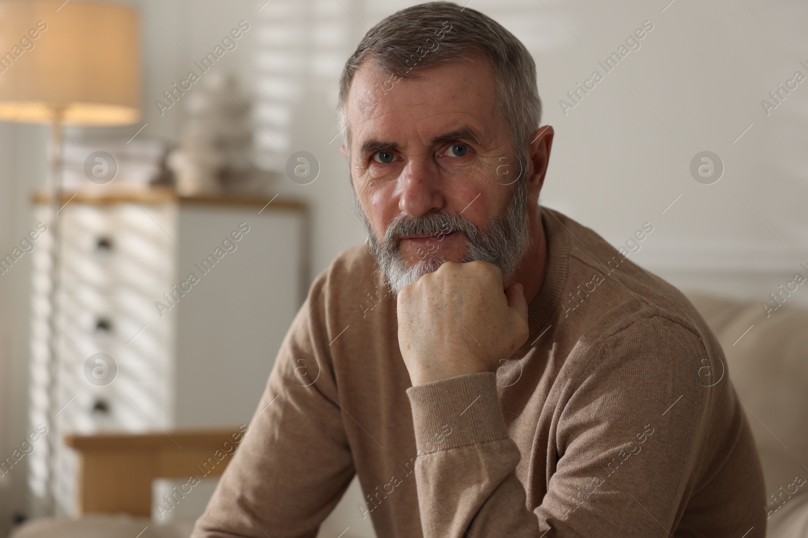 Photo of Portrait of handsome senior man at home