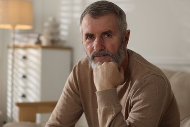 Photo of Portrait of handsome senior man at home