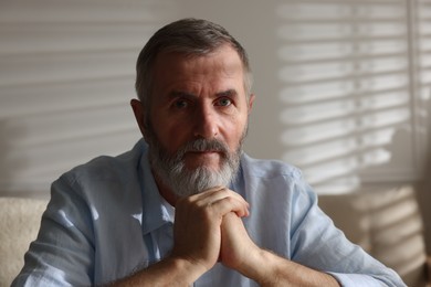 Photo of Portrait of handsome senior man at home