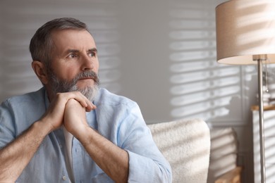 Photo of Portrait of handsome senior man at home