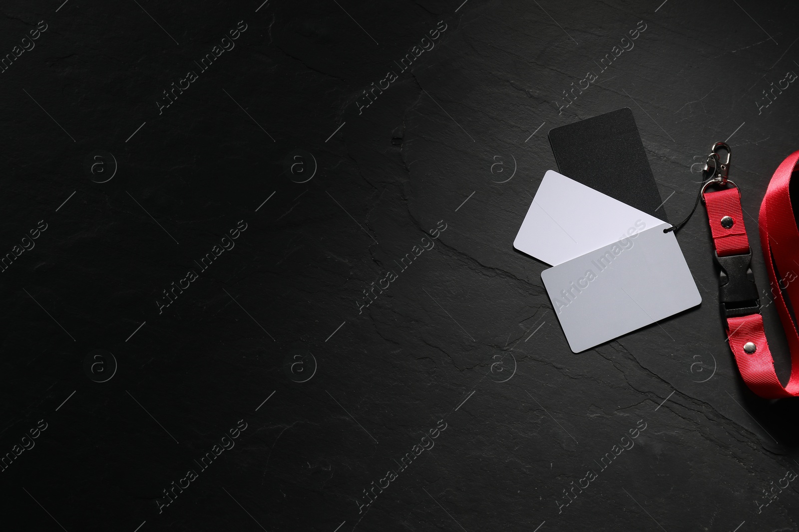 Photo of White balance calibration cards on black background, top view. Space for text