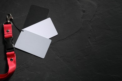 Photo of White balance calibration cards on black background, top view. Space for text