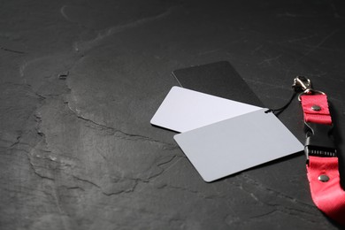 Photo of White balance calibration cards on black background, closeup. Space for text