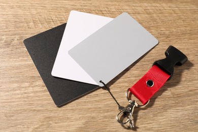 Photo of White balance calibration cards on wooden background, closeup