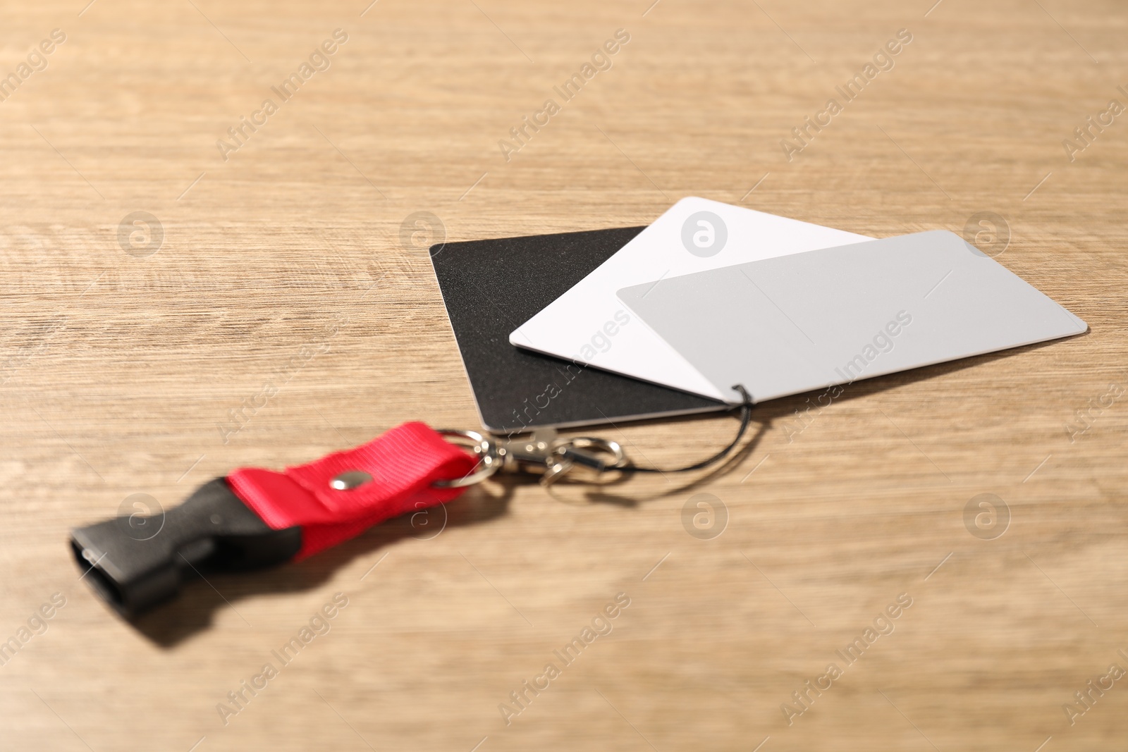 Photo of White balance calibration cards on wooden background, closeup