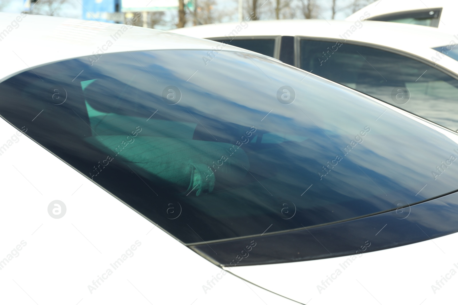 Photo of Modern car with tinting foil on window outdoors, closeup