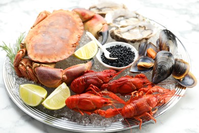 Photo of Many different sea food on white marble table, closeup