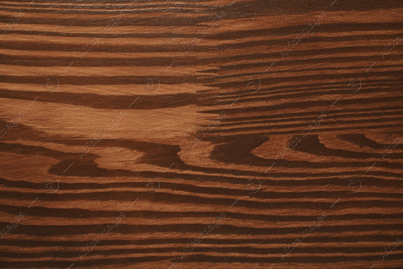 Photo of Texture of wooden surface after applying walnut wood stain as background, top view