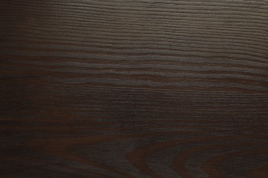 Photo of Texture of wooden surface after applying walnut wood stain as background, top view