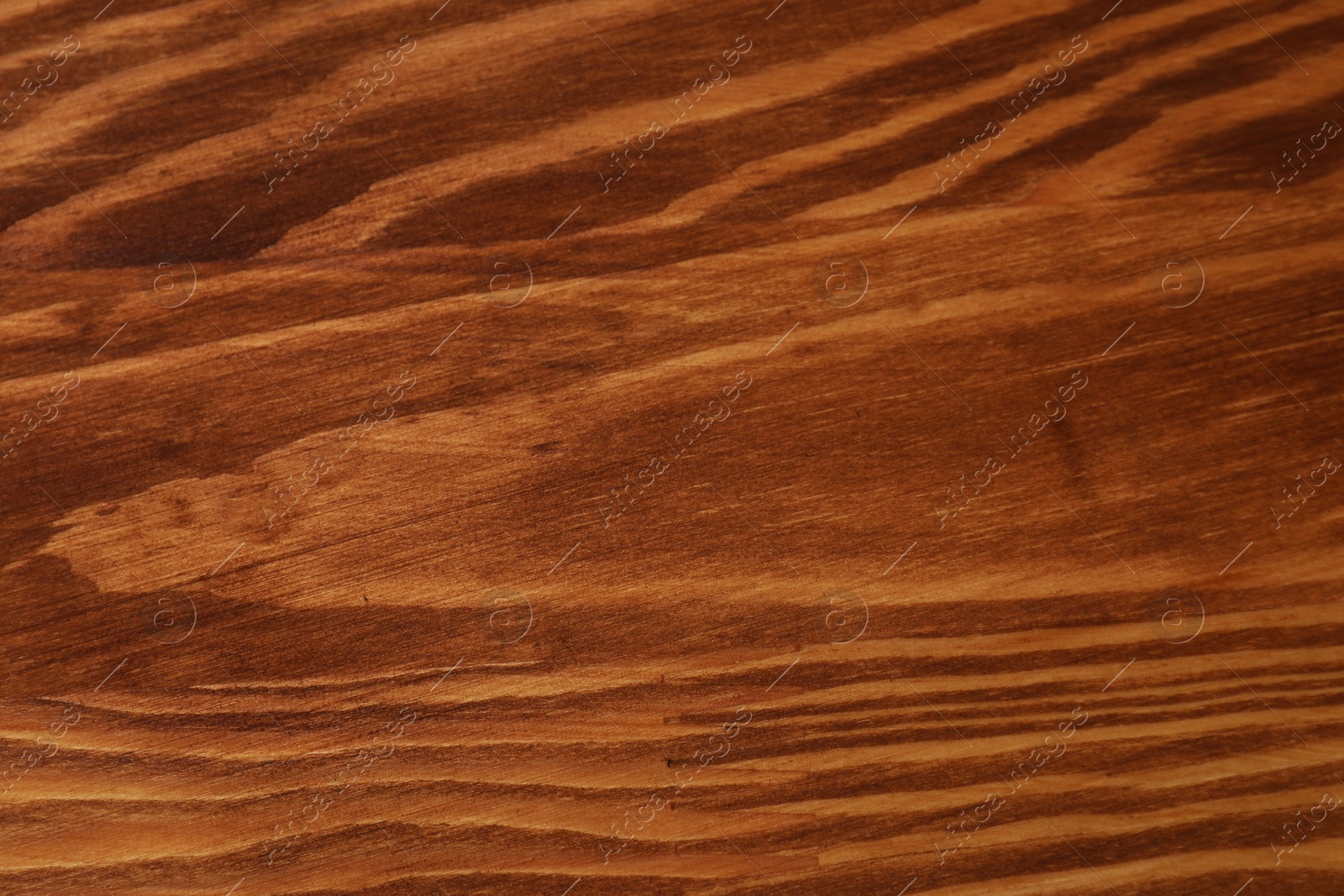 Photo of Applying walnut wood stain. Texture of wooden surface as background, top view