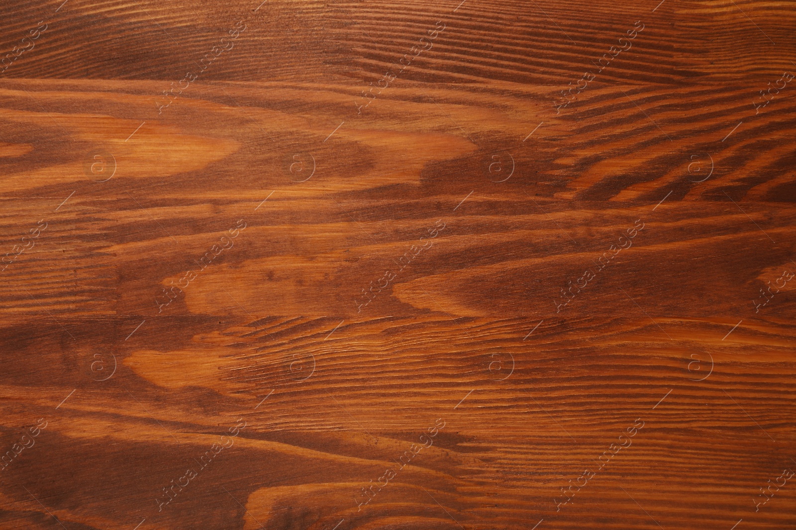 Photo of Applying walnut wood stain. Texture of wooden surface as background, top view