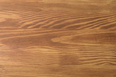 Photo of Applying walnut wood stain. Texture of wooden surface as background, top view