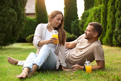 Couple spending time together on green lawn in park