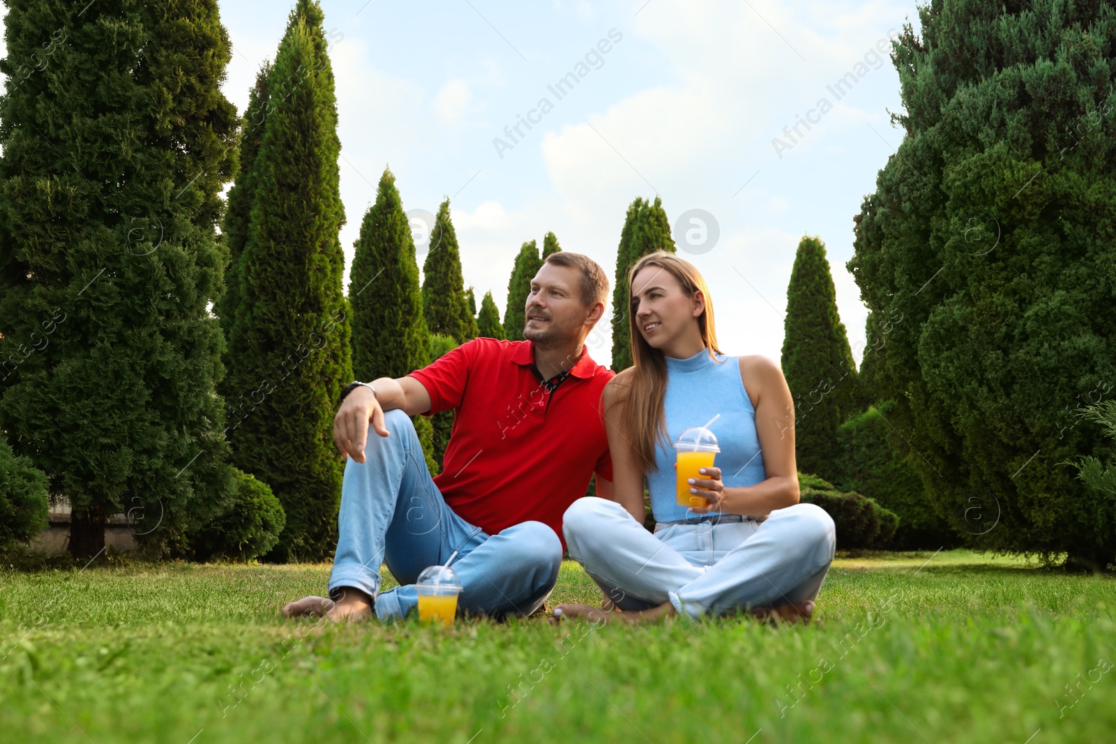 Photo of Couple spending time together on green lawn in park