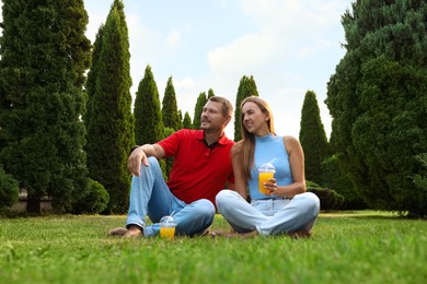 Couple spending time together on green lawn in park