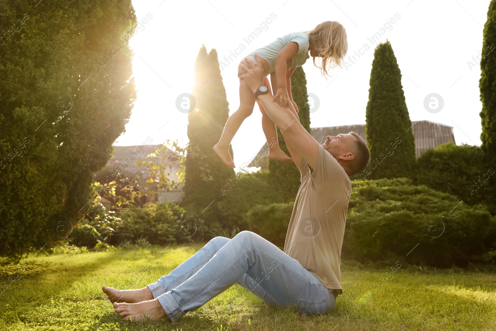 Photo of Father and his daughter spending time together on green lawn in park