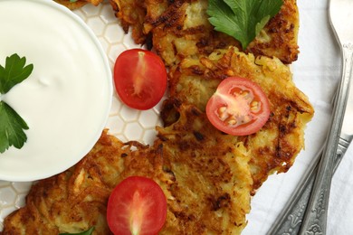 Photo of Delicious potato pancakes served on table, flat lay