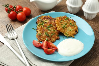 Photo of Delicious potato pancakes served on wooden table, closeup