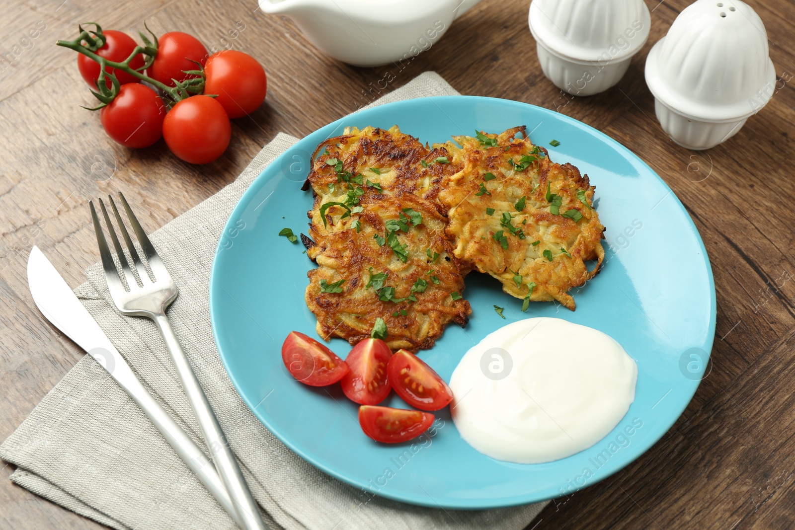 Photo of Delicious potato pancakes served on wooden table, closeup