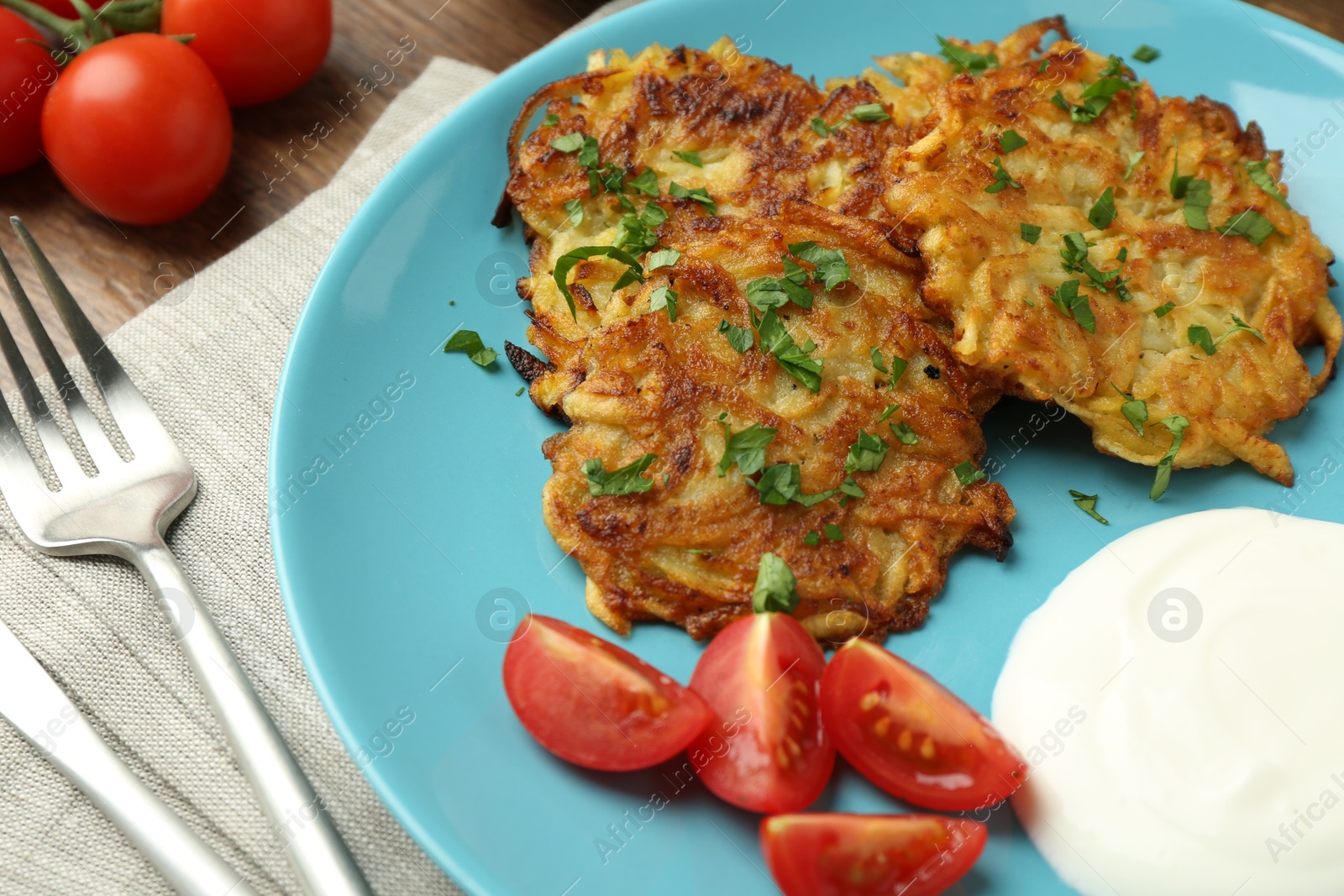 Photo of Delicious potato pancakes served on table, closeup