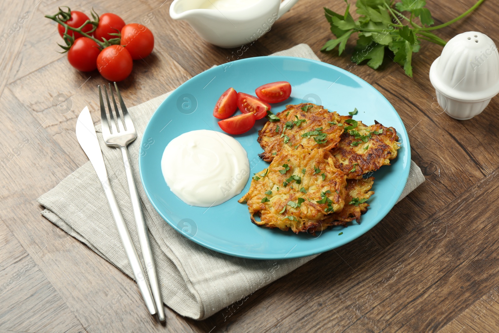 Photo of Delicious potato pancakes served on wooden table, closeup