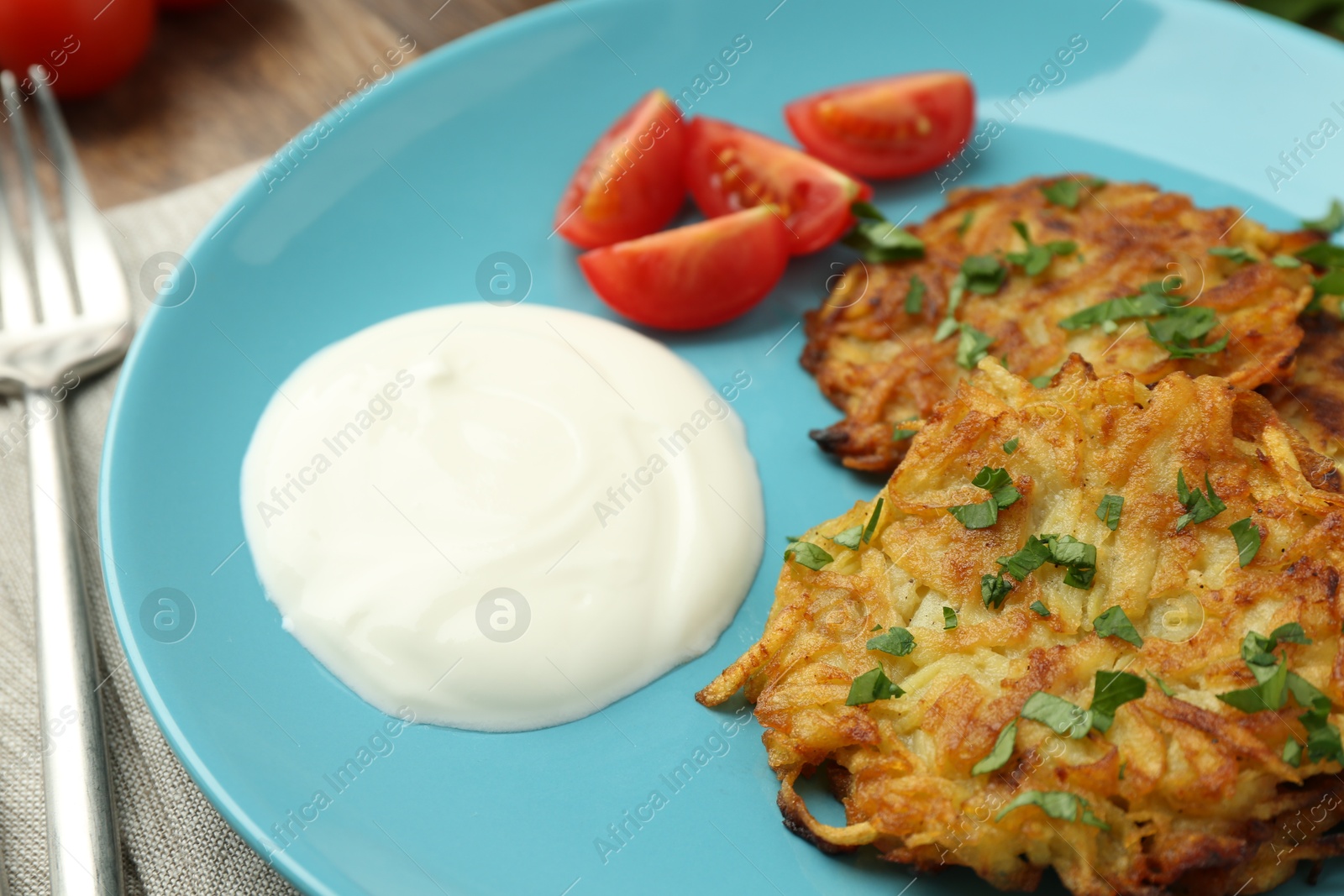 Photo of Delicious potato pancakes served on table, closeup