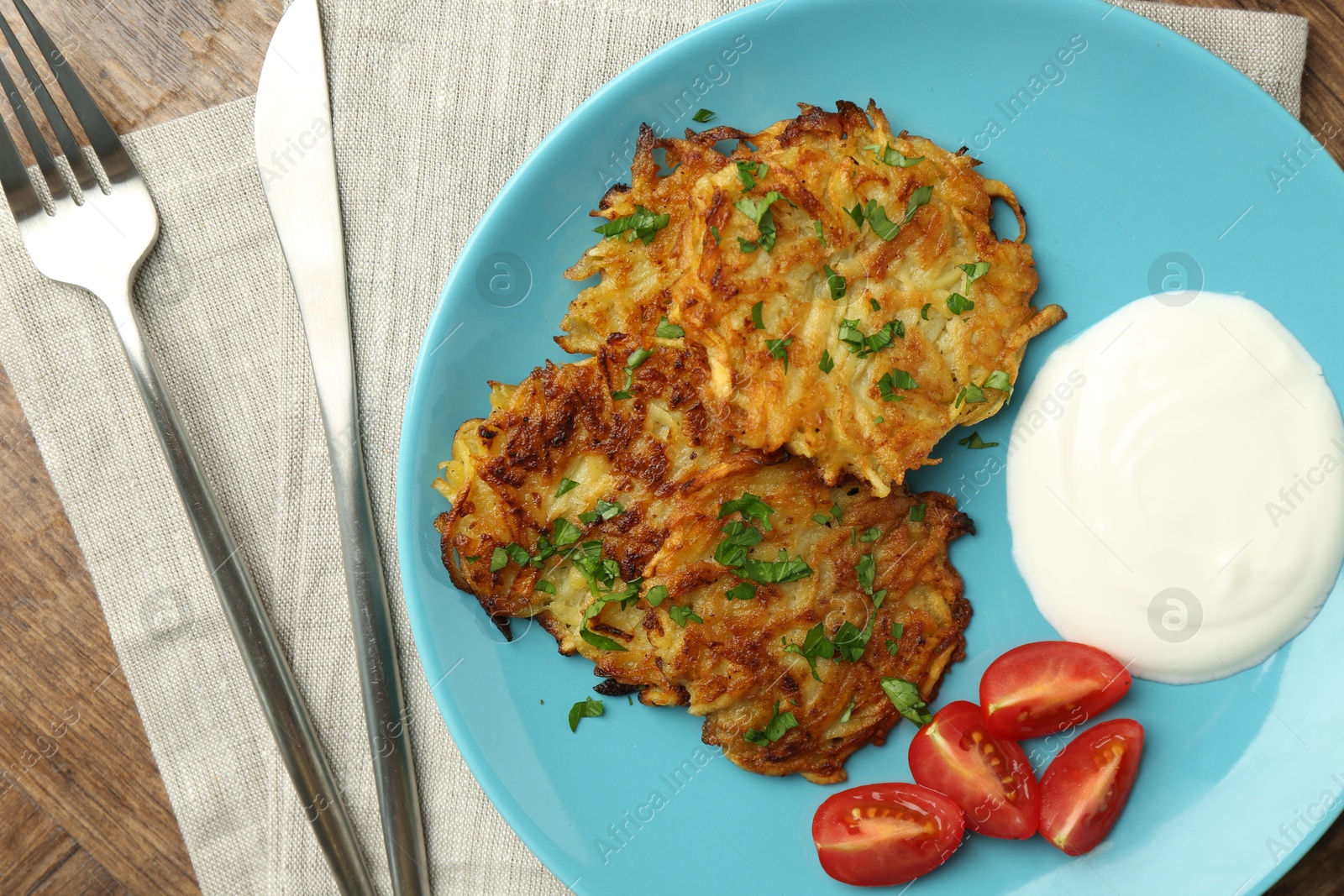 Photo of Delicious potato pancakes served on table, flat lay