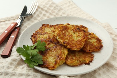 Photo of Delicious potato pancakes served on table, closeup