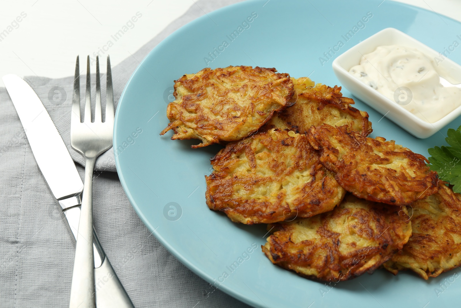 Photo of Delicious potato pancakes served on table, closeup