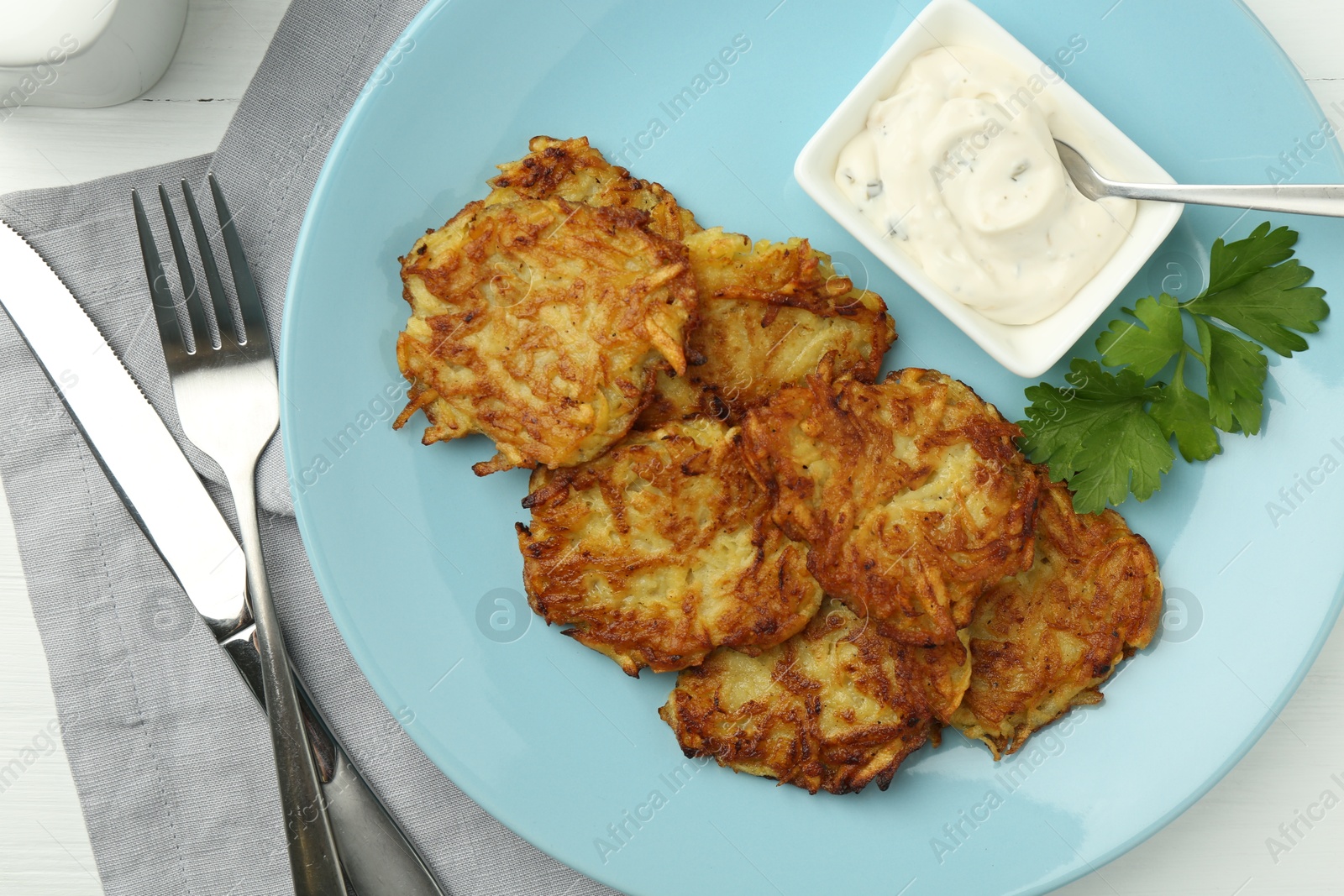 Photo of Delicious potato pancakes served on table, flat lay