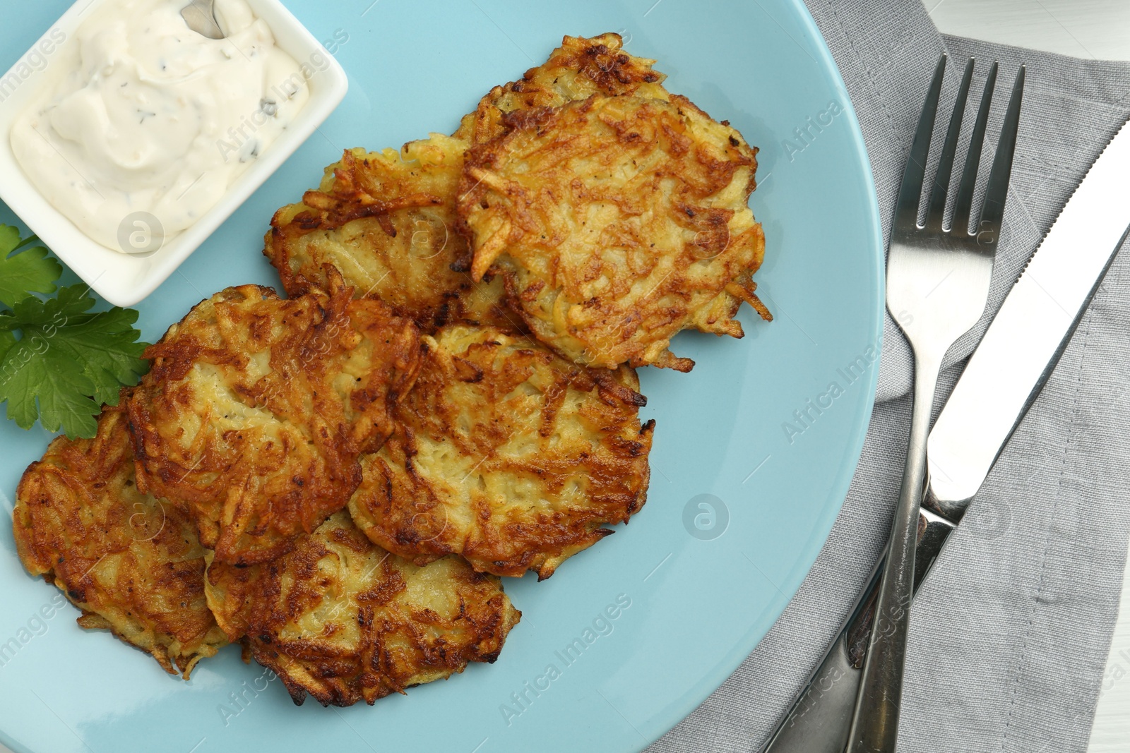 Photo of Delicious potato pancakes served on table, flat lay