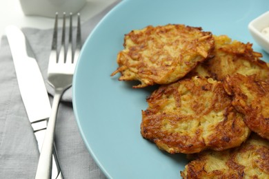 Delicious potato pancakes served on table, closeup