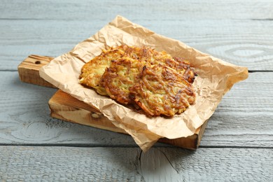 Delicious potato pancakes on grey wooden table, closeup