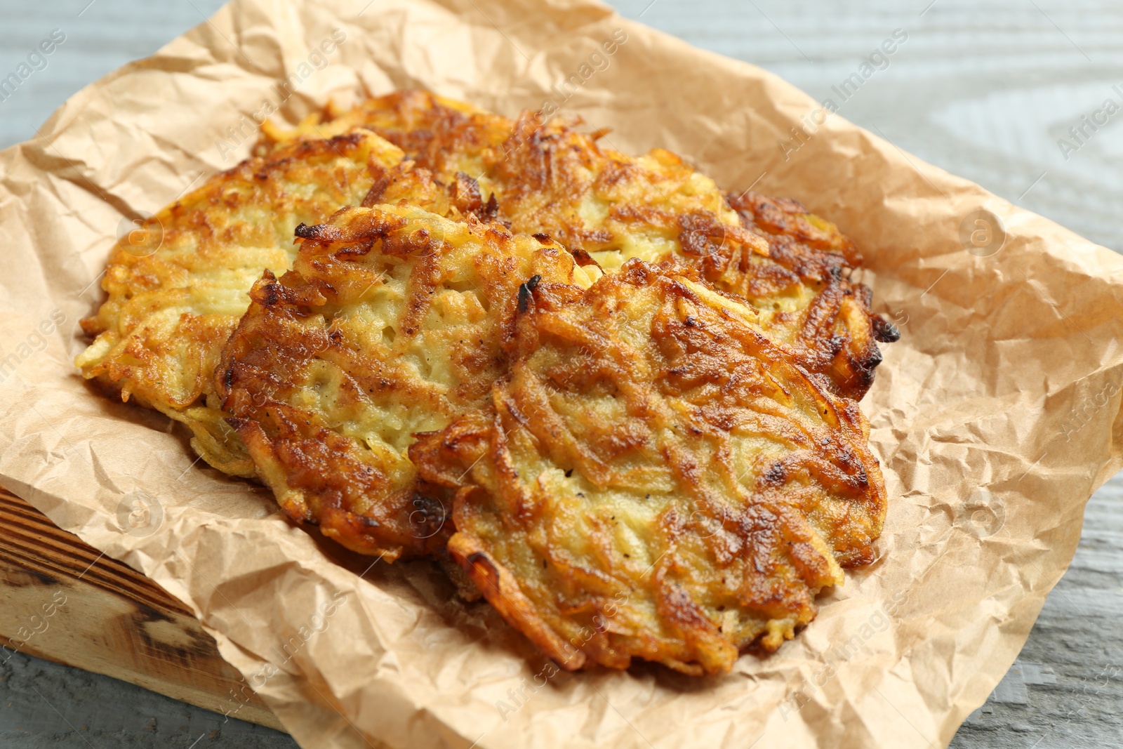 Photo of Delicious potato pancakes on grey table, closeup