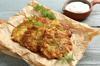 Photo of Delicious potato pancakes served on grey wooden table, closeup