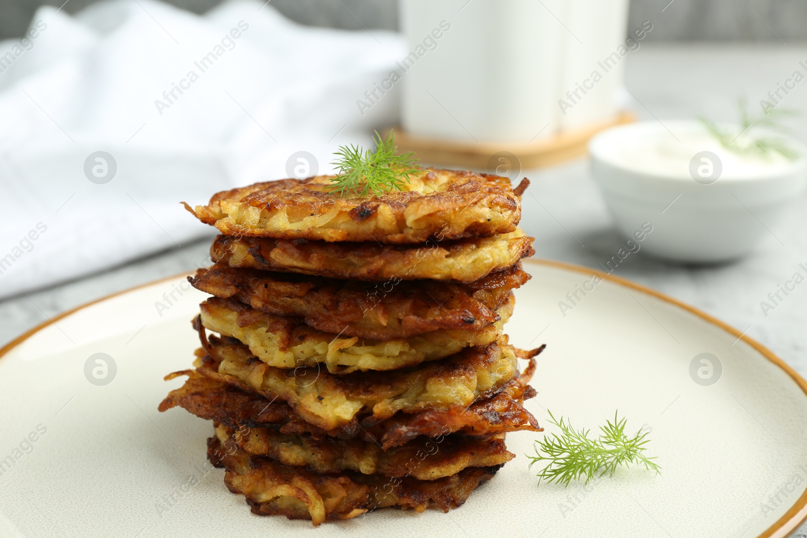 Photo of Delicious potato pancakes with fresh dill on table, closeup