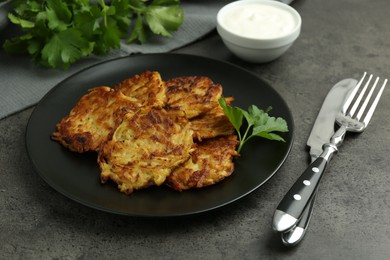 Photo of Delicious potato pancakes served on grey table, closeup